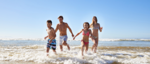 Family enjoying things to do in Carlsbad in June at the beach with kids
