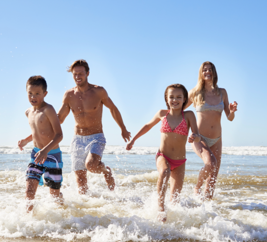 Family enjoying things to do in Carlsbad in June at the beach with kids