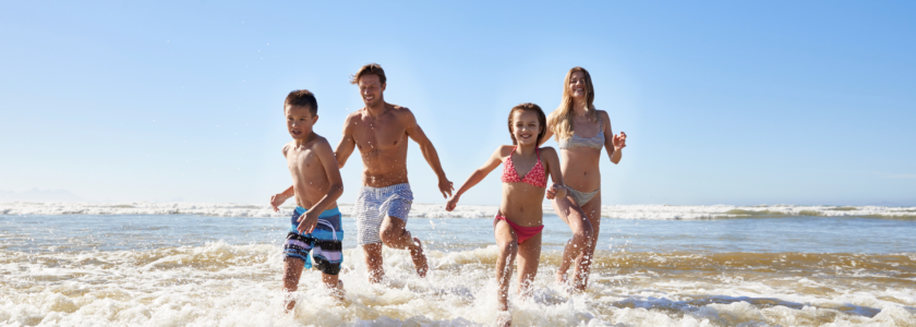 Family enjoying things to do in Carlsbad in June at the beach with kids